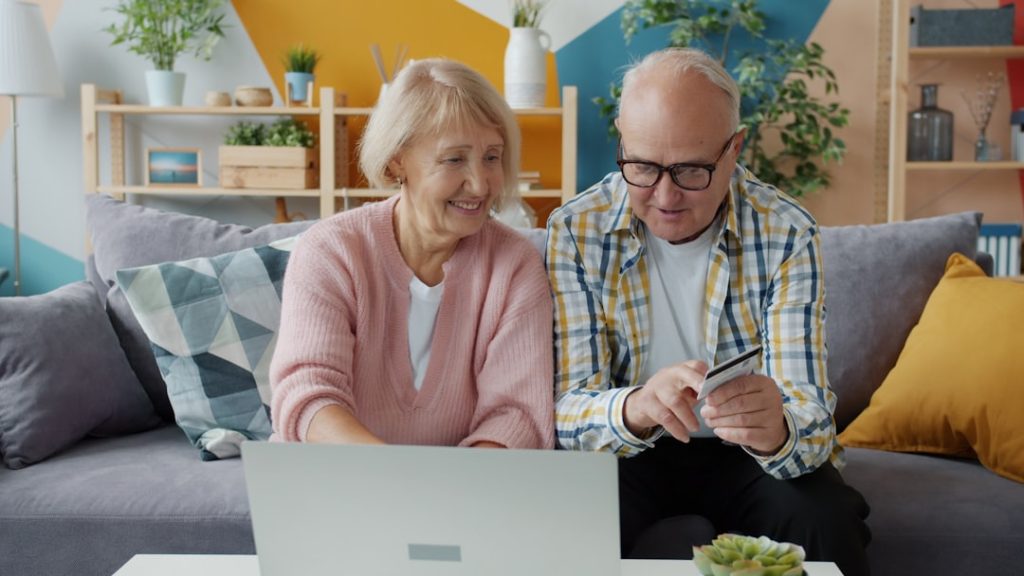The Art of Drawing Readers In: Your attractive post title goes here Cheerful elderly people man and woman are making cashless online payment with bank card using laptop at home. Money, retirement and shopping concept.